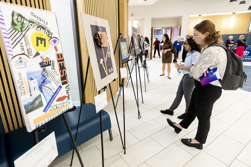 Students attend the Arts for Optimal Health pop-up art show honoring Bobby Levin and art therapy for cancer patients and caretakers