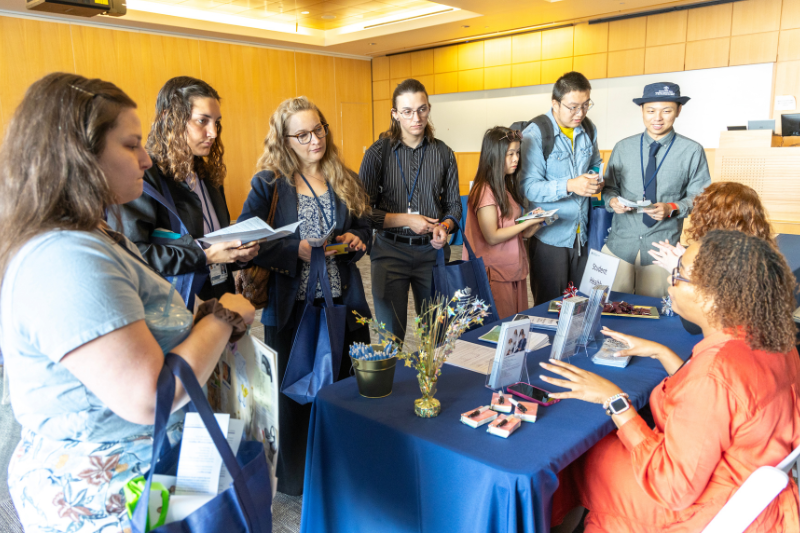 New health professions students visit an information table during the orientation Resource Fair