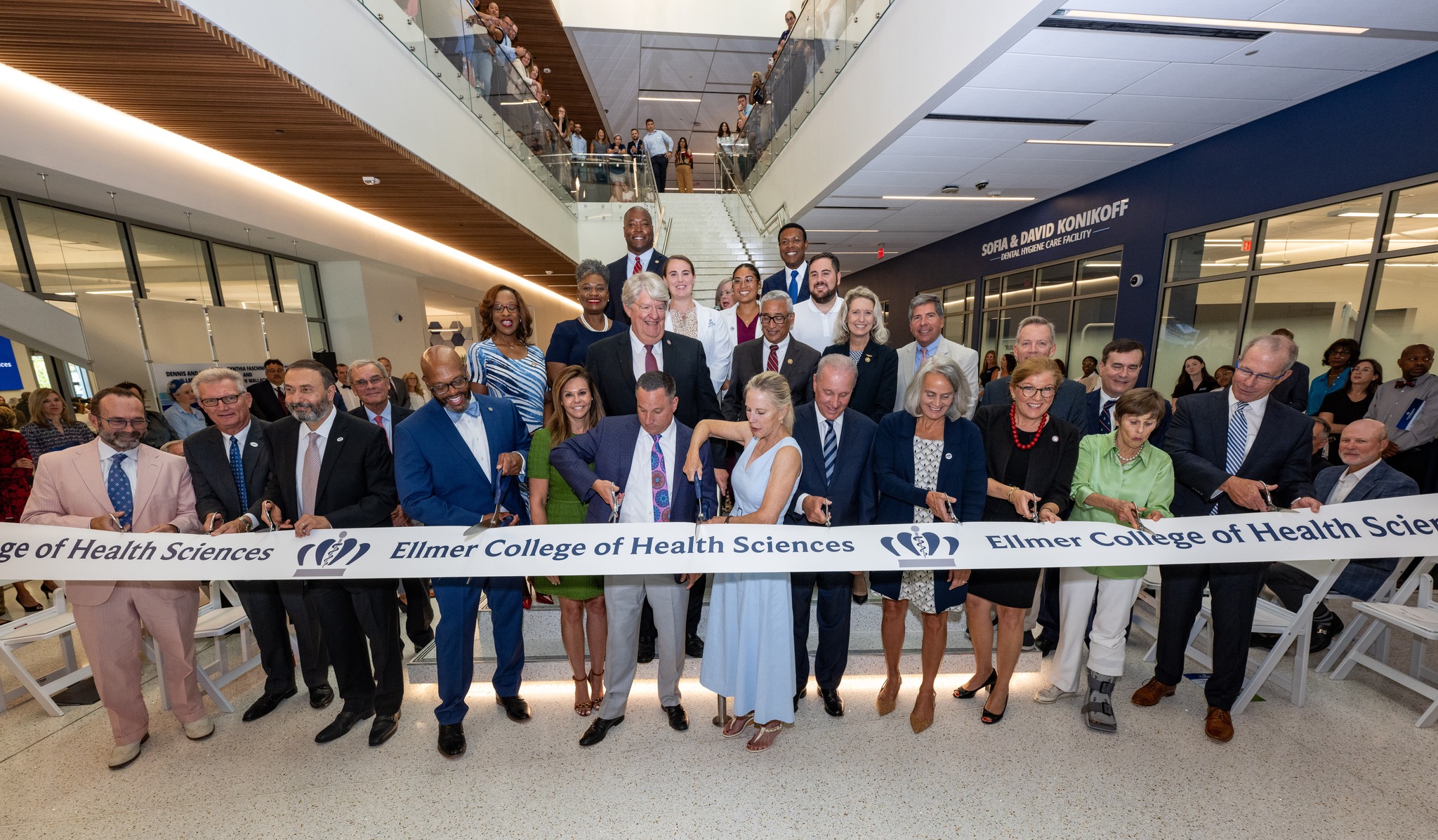 A group of leaders from ODU and the community cut a ribbon during the opening celebration of the new health sciences building