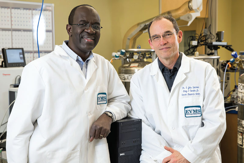 Dr. Julius Nyalwidhe and Dr. John Semmes in the Leroy T. Canoles Jr. Cancer Research Center in Lester Hall.