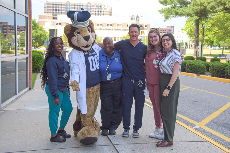 Big Blue mascot with faculty and staff