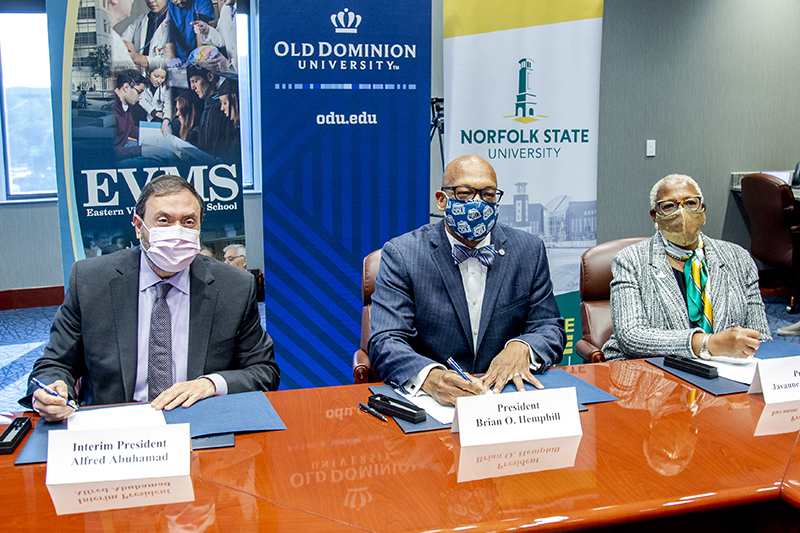 Leaders from EVMS, ODU and NSU pose for a photo during the MOU signing ceremony.