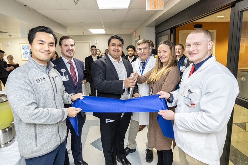 group of people cutting ribbon