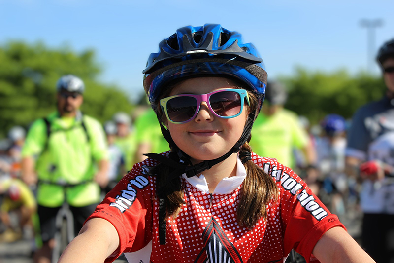 pic of girl on bike with helmet.