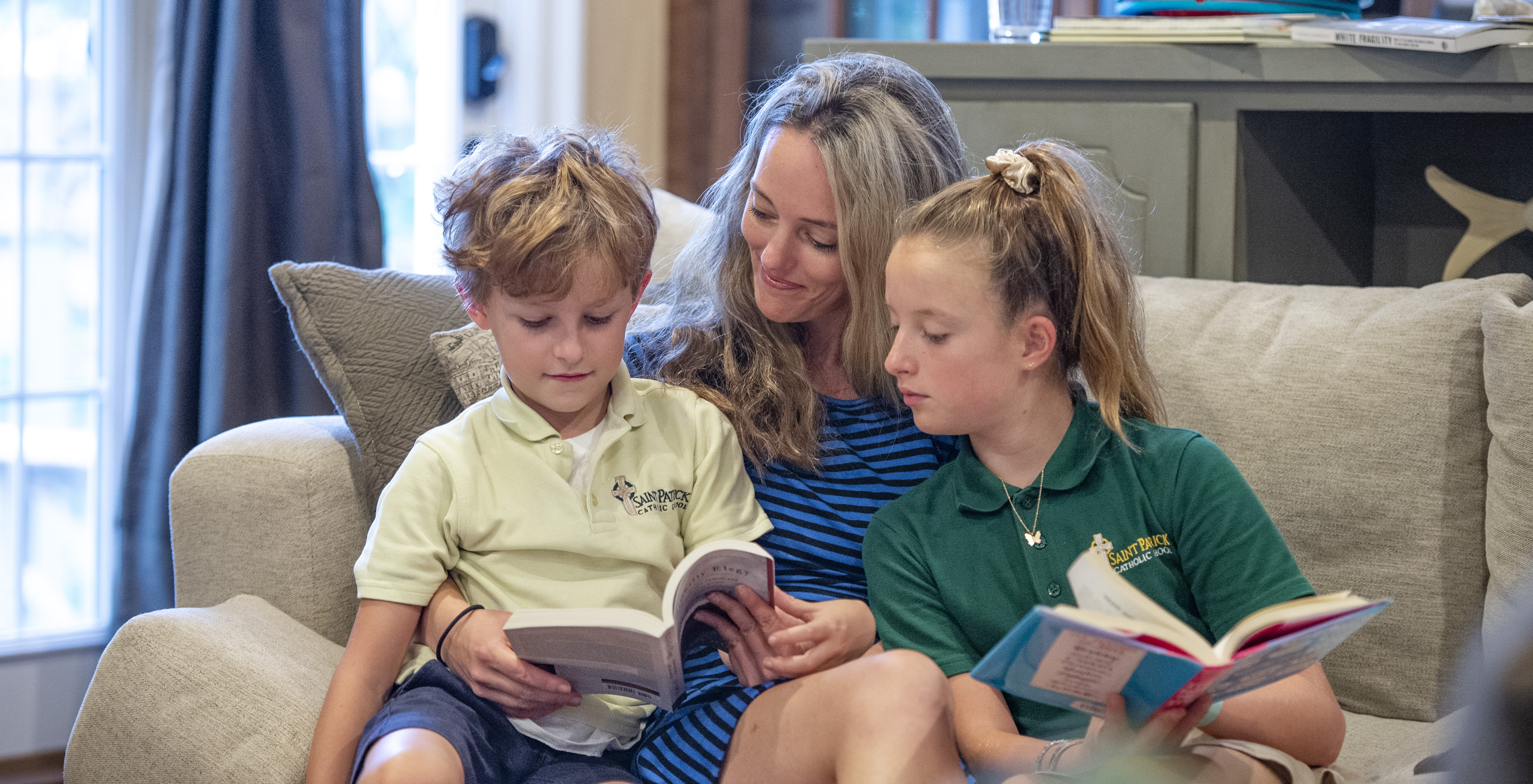 Dr. Hooper reading with her two children in their family home.