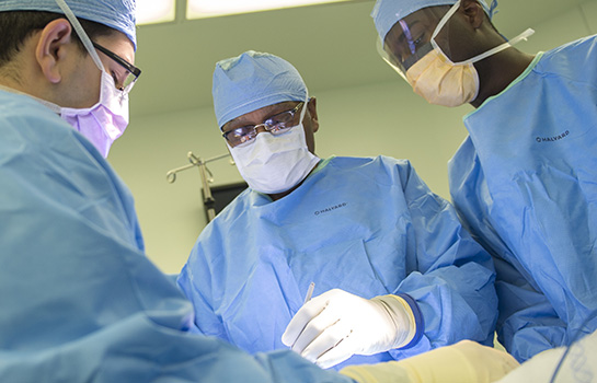 L.D. Britt, MD performing surgery in blue scrubs